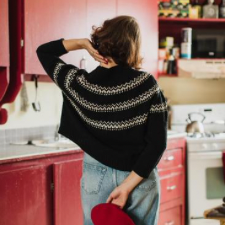 Loose-fitting pullover with geometric colorwork in bands around the yoke.