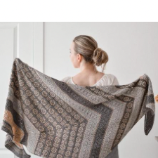Large colorwork and textured shawl in shallow triangle shape. Colorwork echoes traditional Latvian weaving.