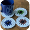 Round granny circle coasters designed as eyeballs, including irises and a highlight on each pupil.