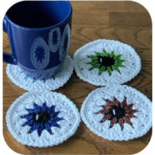 Round granny circle coasters designed as eyeballs, including irises and a highlight on each pupil.