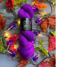 Very bright red-violet yarn shown with matching Halloween spider lights
