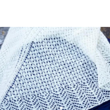 A simple, sinuous lace pattern borders the upper edge and creates the centre spine. A deep border of zig-zag lace finishes this lightweight shawl.