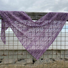 Asymmetric triangular shawl patterned after tiny flowers.