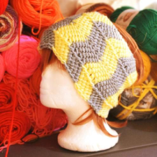 Tunisian crochet ear warmer has two-color zigzag repeat.