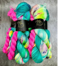 Sock sets with hot pink heel and toe miniskein. The main skein is Miami Vice aqua with splashes of neon yellow and purple.