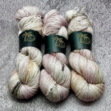 Softly variegated yarn in colors of weathered wood with a bit of pink, in sparkle yarn.