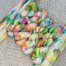 White yarn with splashes of blue, pink, yellow and green.
