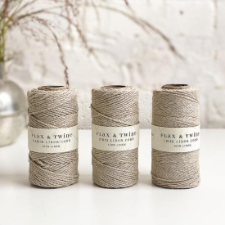 Three spools of natural-color linen cord.