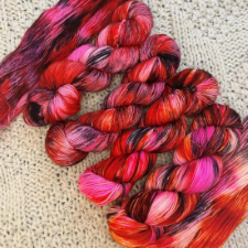 Red yarn with splashes of pink and maroon.