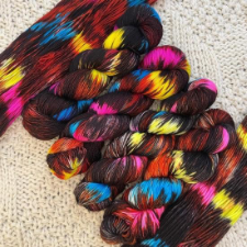 Black yarn with splashes of neon yellow, blue, pink and red.