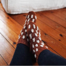 Dark socks featuring contrasting pine motifs.