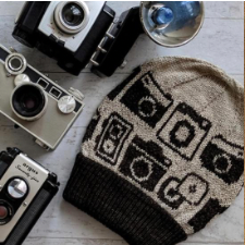Two-color beanie with colorwork of old-fashioned cameras.