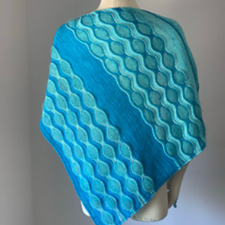 Two color rectangular shawl with short rows that create the illusion of waves.