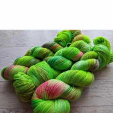 Neon green laceweight yarn with splashes of pink.