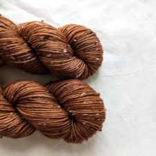 Two skeins of a warm brown tweed.