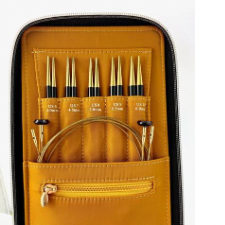 Inside of leather case shows pocket for cables, individual marked pockets for five sets of interchangeable needles, and small zippered pocket for accessories.
