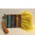 Project bag with wrist strap. Colorful fabric bag ends in extensive golden floof coming out the side of the bag like a mane.