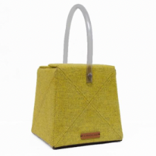 Cube shaped wool bag in gold wool fabric. Opens via two flaps at the top and has a tubular plastic handle.