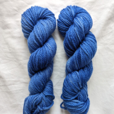 Semi-solid true blue yarn skeins.