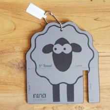 Wooden tassel maker with adorable cartoon sheep.