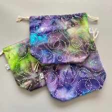 Flat bottom 11 inch by 9 inch drawstring project bag. Fabric looks like jewel-tone batik.