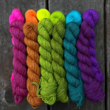 Two rainbow rows of minis, one neon and the other more muted tones of the same colors.