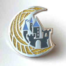 Enamel Pin of crescent moon made of yarn, cradling a castle.