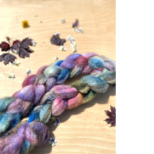 Hand-dyed braid of Merino roving in sidewalk chalk colors.