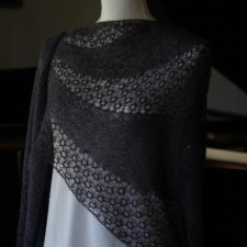 Mirroring the subtle asymmetry of its namesake Debussy song, this swinging top-down crescent shawl utilizes short rows to shape alternating bands of garter stitch and lace into widening curves, dramatically balancing the piece off-center.