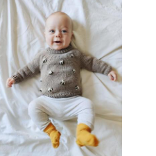 Happy baby in long-sleeve crew neck festooned with bees.