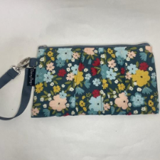 Gathered clutch with wristlet that can be unclipped to join the bag to another.