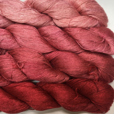 Four solid skeins from medium pink to crimson.