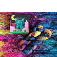 Two twisted skeins in deep cool tones of yellow, hot pink, blue and teal.