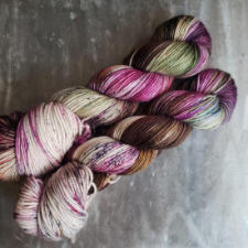 Variegated yarn from palest pink to rusty maroon, and splashes of sage green
