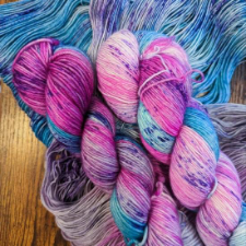 Variegated yarn in the colors of the trans and bisexual flag.