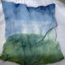 Sheet of fiber, green at the bottom and blue at the top, like a landscape.