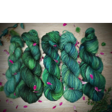 Deep green tonal yarn on five bases, sprinkled with bright pink fresh flower blossoms.