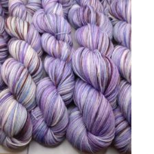 Variegated yarn in shades of lavender with bits of brown.