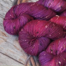 Tonal tweed yarn in berry shades.