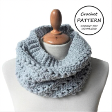 Crocheted cowl with ribbed edges and alternating rows of openwork stitches throughout.