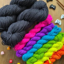 Two deep gray full skeins plus six neon brights for Jamie Lomax’s cowl pattern