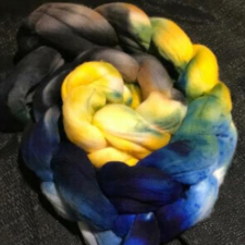 Coil of braided top in yellow, green and blue.