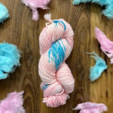 Palest pink yarn with splashes of light blue, with tufts of matching cotton candy (candy floss).