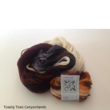 Variegated yarn in warm deep brown, orange and cream.