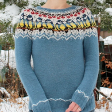 Colorwork pullover with cherries and brightly colored birds. There is simple colorwork at the hem and cuffs also.