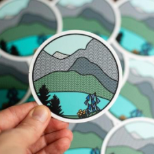 Sticker of a mountain landscape where the mountains are in stockinette