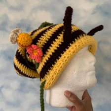 Black and yellow striped crochet slouch with antennae, plus a flower and a bee applique.
