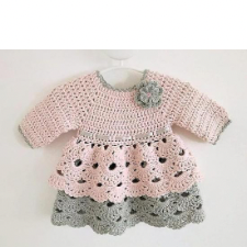 Pink and gray long sleeve dress. Top is solid and has contrasting color at neckline and cuffs. Contrasting crocheted flower is over the heart. Skirt is in two openwork layers, one in pink and one in gray.
