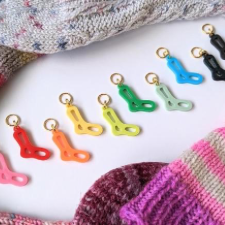 Tiny plastic sock blocker stitch markers in 10 colors.