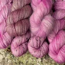 Pink tonal yarn on a variety of bases.